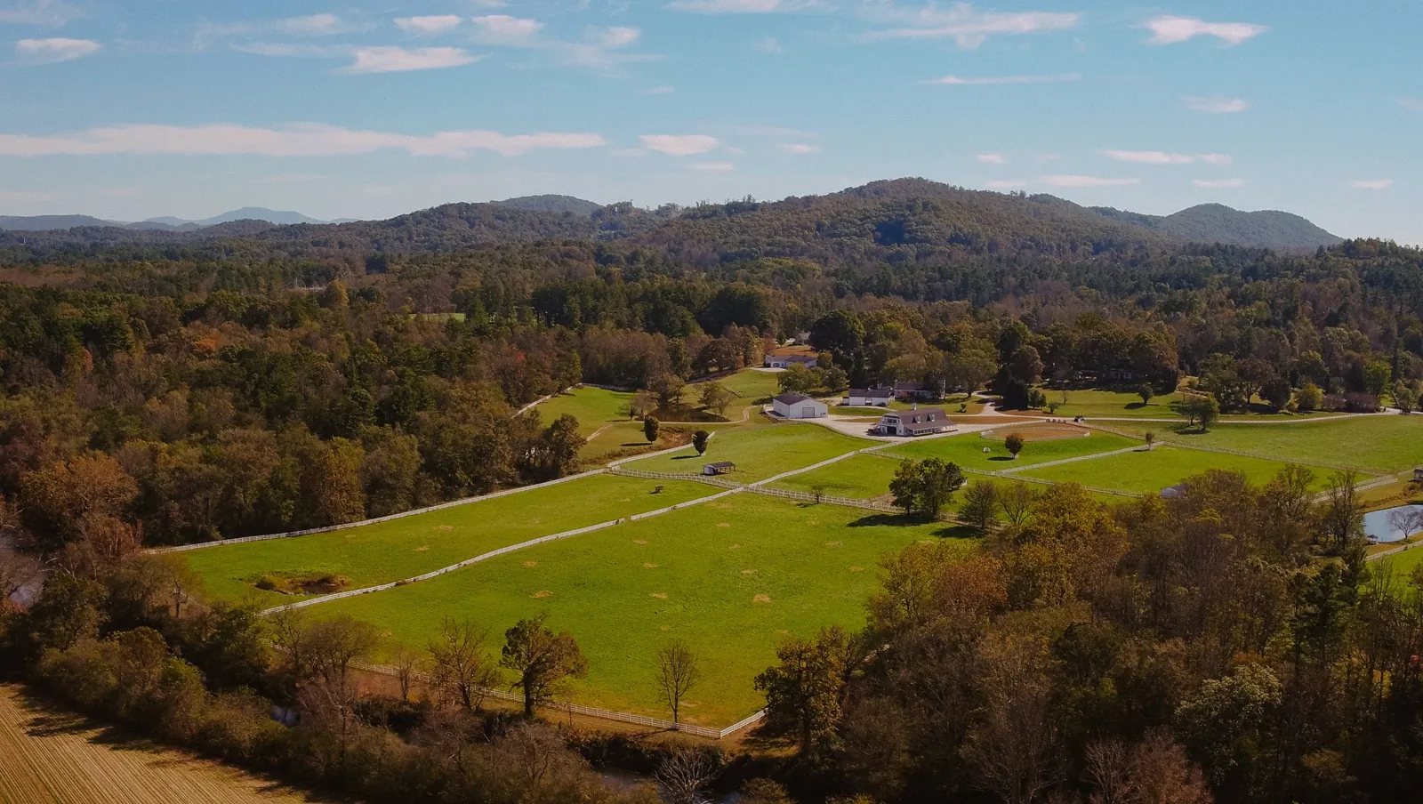 Aerial view of the 85 acre Horse Shoe Farm estate with the Blue Ridge Mountains behind it